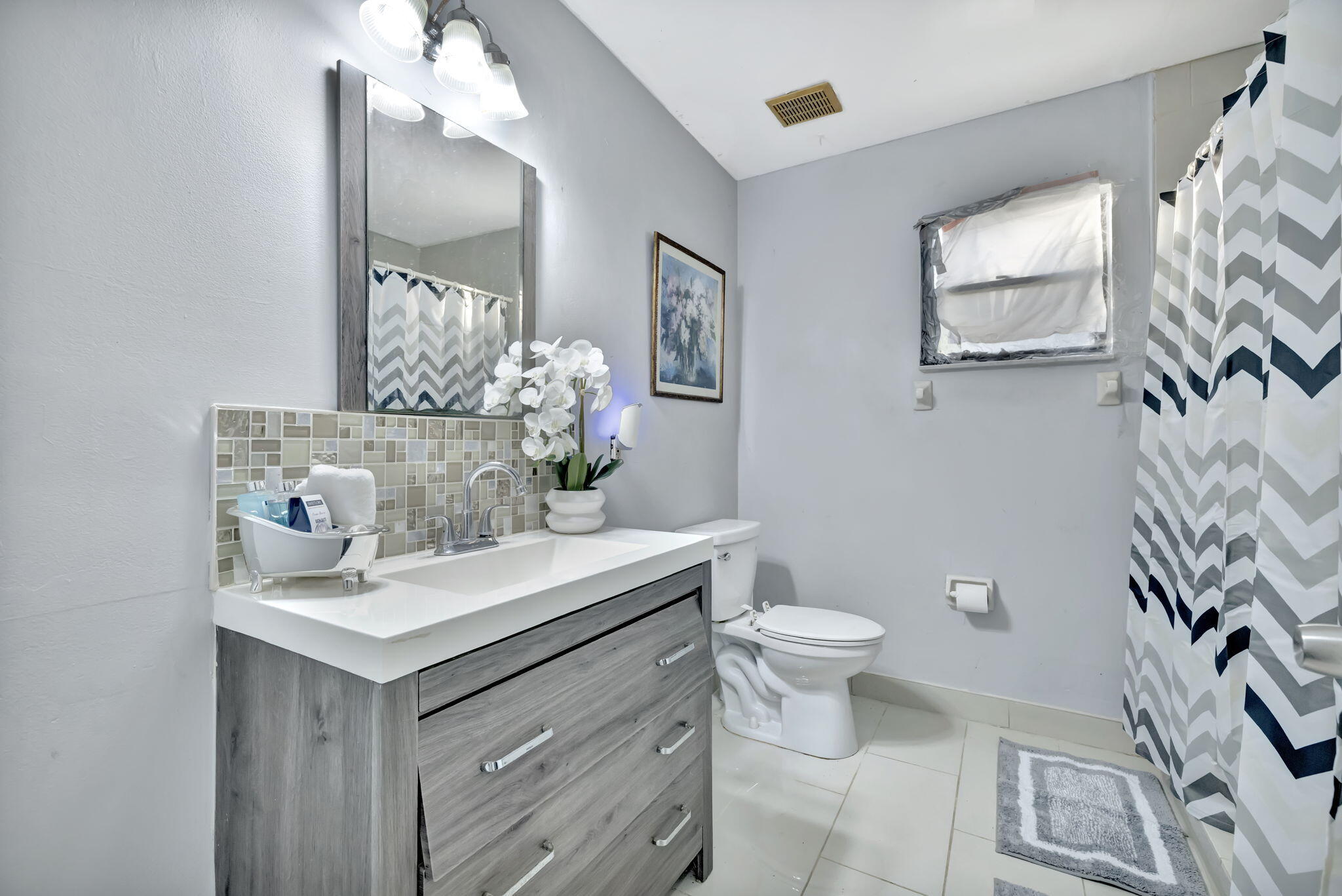2080 Colonial Road, Unit 1 Fort Pierce, FL 34950 - Photo 17 of 21 a bathroom with a sink toilet and mirror