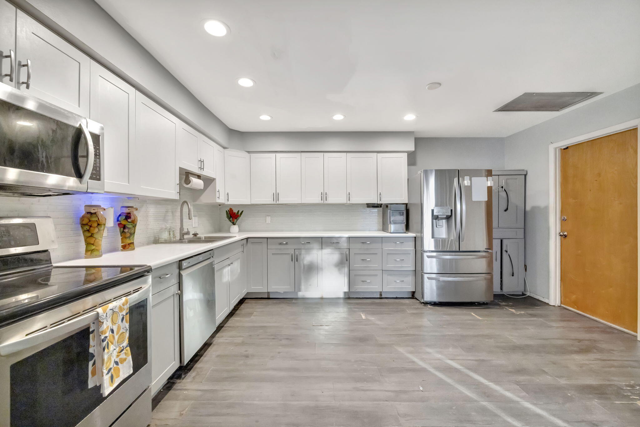 2080 Colonial Road, Unit 1 Fort Pierce, FL 34950 - Photo 3 of 21 a large white kitchen with stainless steel appliances granite countertop a stove and a refrigerator