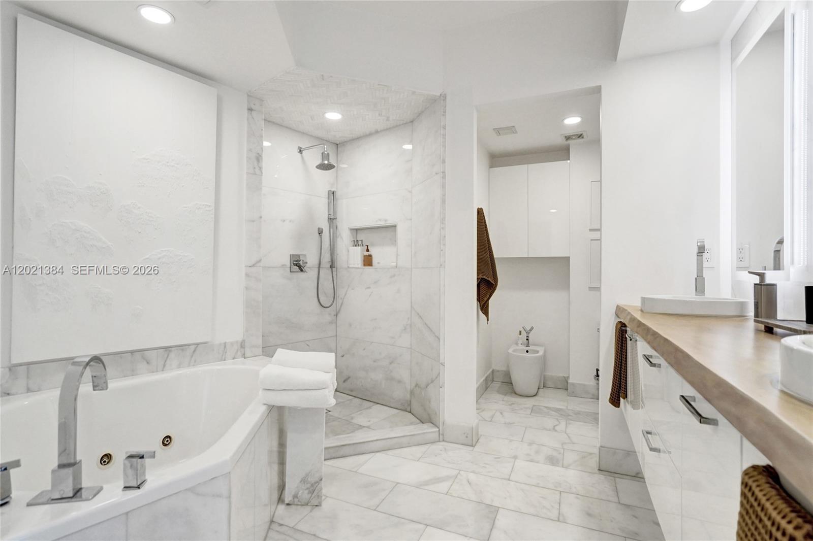 400 Alton Road, Unit PH11 Miami Beach, FL 33139 - Photo 30 of 49 a bathroom with a sink a toilet and a bathtub