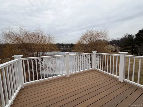 a balcony with wooden floor and fence