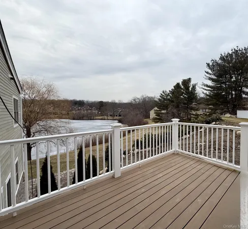a balcony with wooden floor and fence
