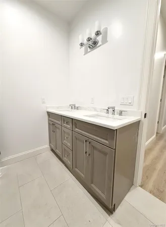 a bathroom with a sink vanity and mirror