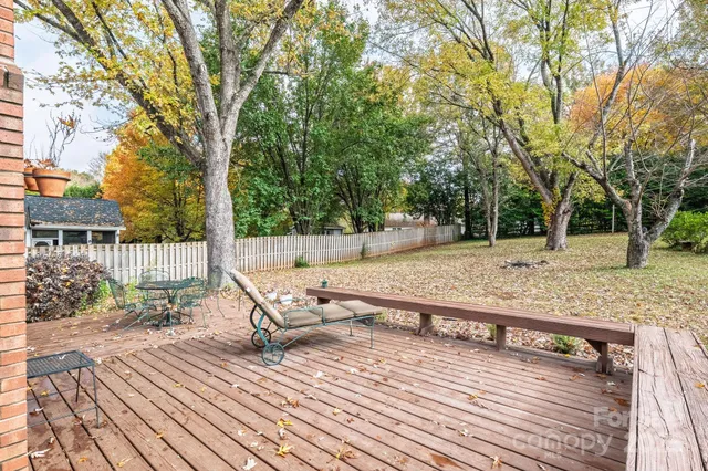 a park view with a bench next to a yard