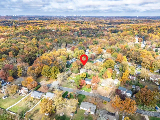a front view of house with yard and trees around