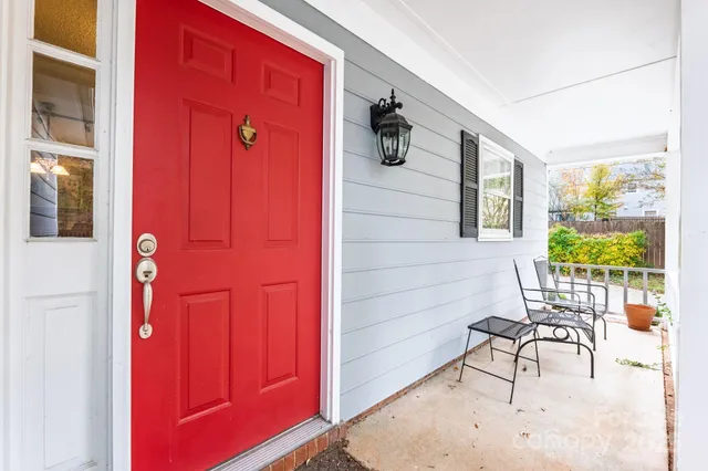 a view of a porch with a table and chairs and potted plants