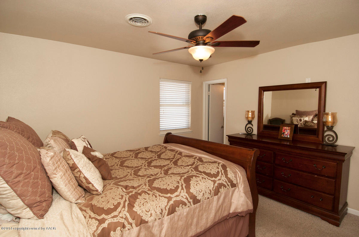 2607 Darrell Avenue Amarillo, TX 79110 - Photo 15 of 28 a bedroom with a bed and a mirror on dresser