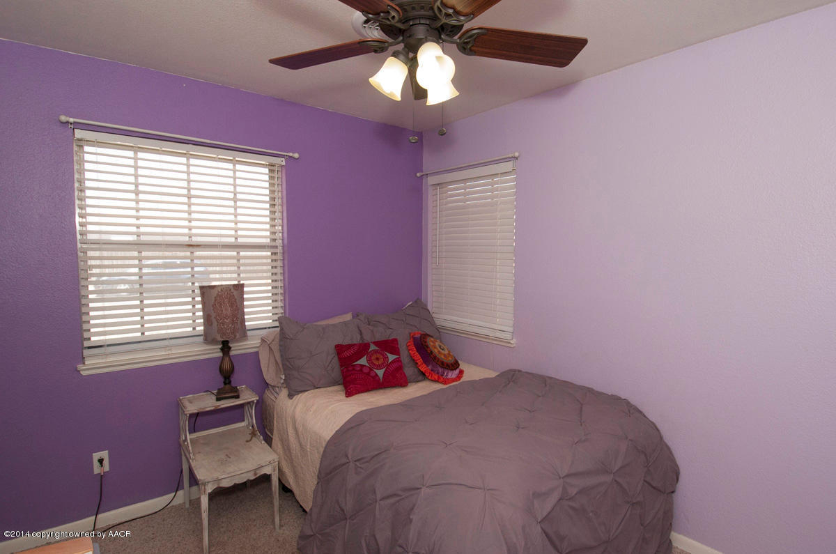 2607 Darrell Avenue Amarillo, TX 79110 - Photo 19 of 28 a bedroom with a bed and a chandelier