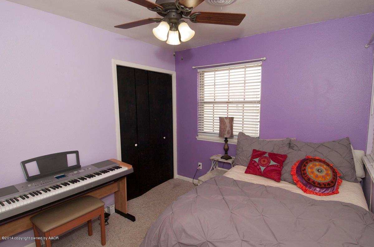 2607 Darrell Avenue Amarillo, TX 79110 - Photo 20 of 28 a bedroom with a bed and a window