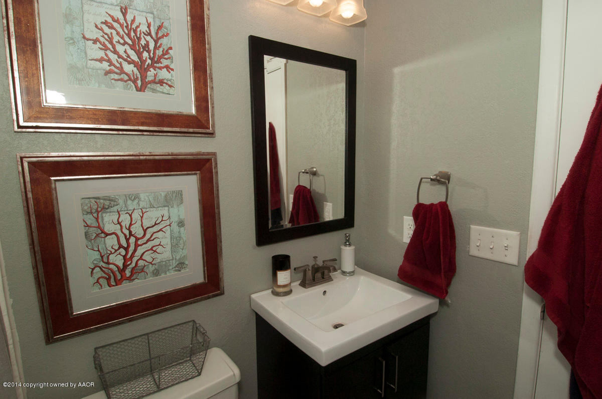 2607 Darrell Avenue Amarillo, TX 79110 - Photo 22 of 28 a bathroom with a sink and a mirror