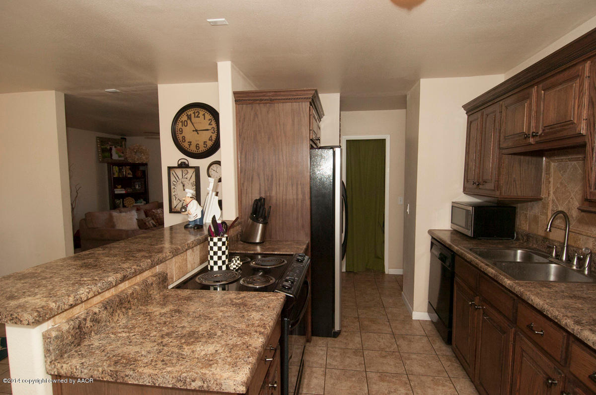 2607 Darrell Avenue Amarillo, TX 79110 - Photo 7 of 28 a kitchen with a refrigerator and a sink