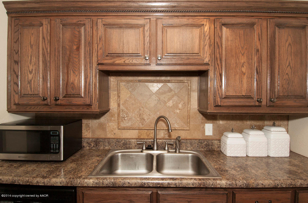 2607 Darrell Avenue Amarillo, TX 79110 - Photo 9 of 28 a kitchen with granite countertop a sink and cabinets