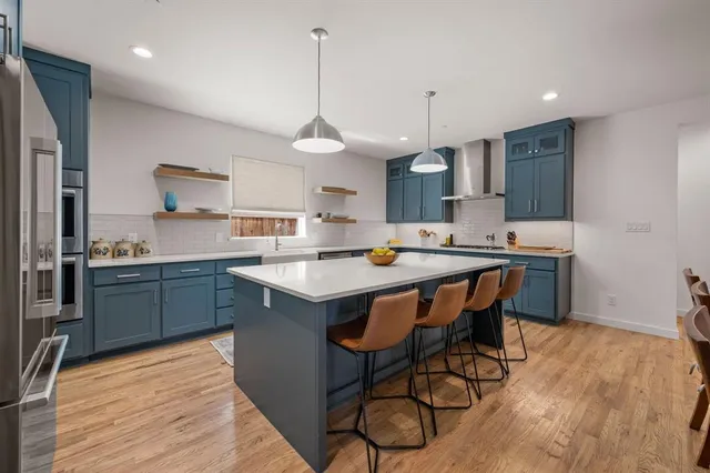a kitchen with a sink cabinets and wooden floor