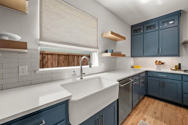 a kitchen with a sink cabinets and window
