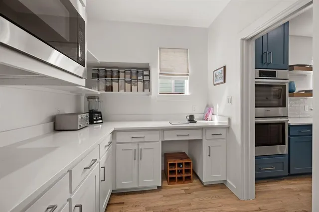 a kitchen with cabinets and stainless steel appliances