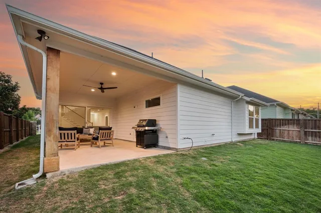 a backyard of a house with table and chairs