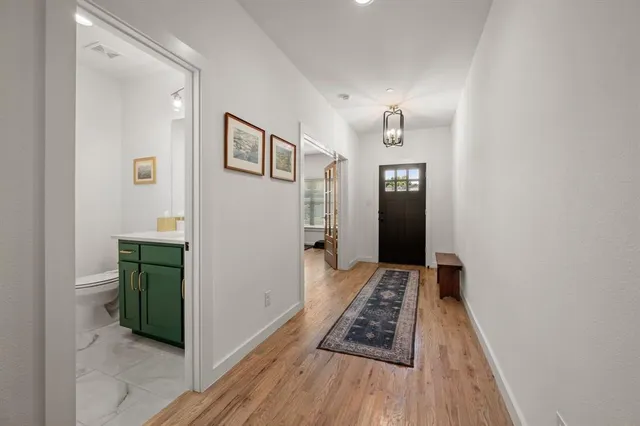 a view of a hallway view with wooden floor and staircase