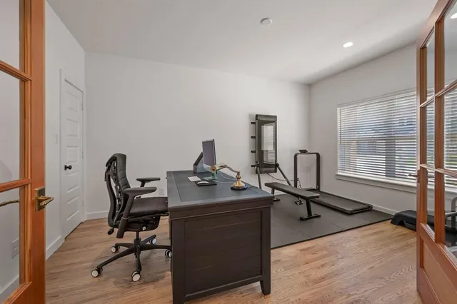 a view of a workspace with furniture and a window