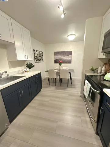 a view of kitchen with sink microwave and stove