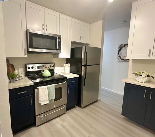 a kitchen with a sink appliances and cabinets