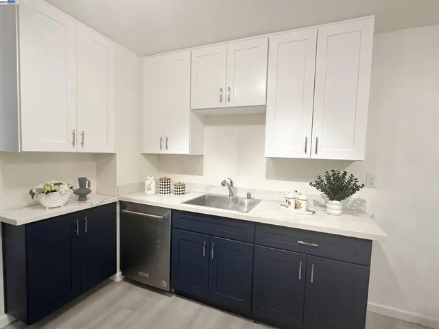 a kitchen with a sink and cabinets