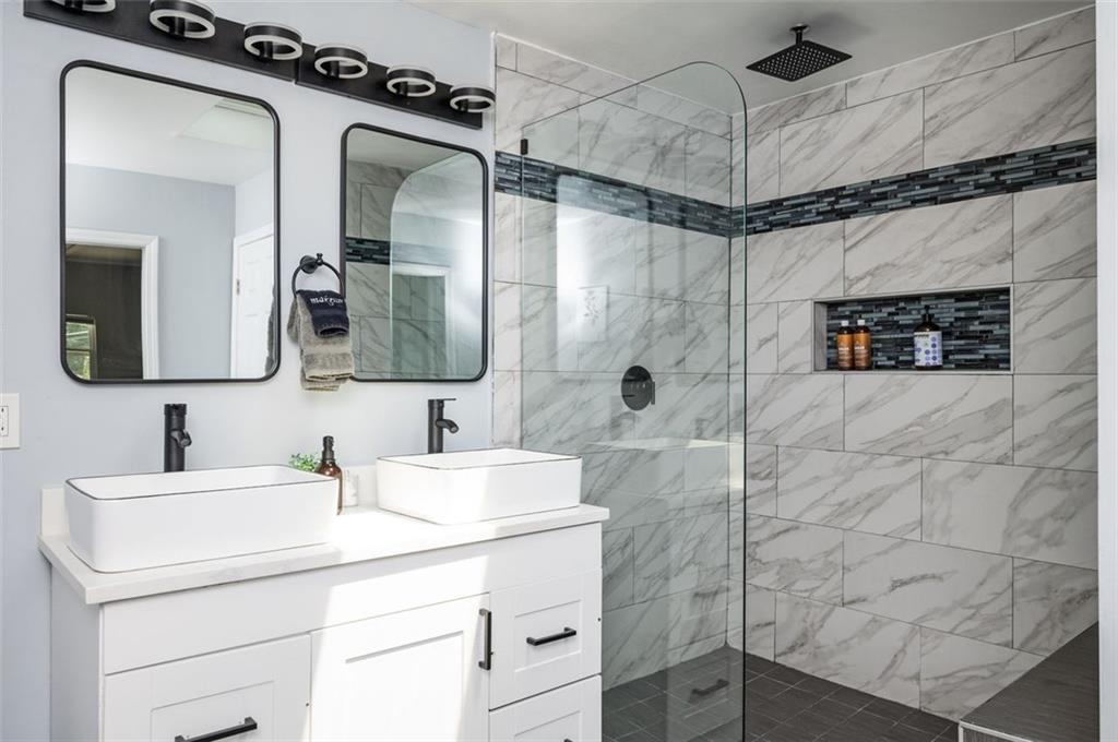 1778 Flintwood Drive Southeast Atlanta, GA 30316 - Photo 11 of 30 a bathroom with a sink mirror and shower