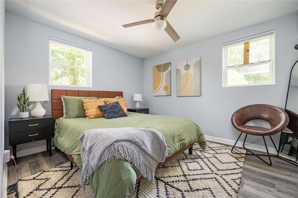 1778 Flintwood Drive Southeast Atlanta, GA 30316 - Photo 13 of 30 a bedroom with a bed and a chandelier