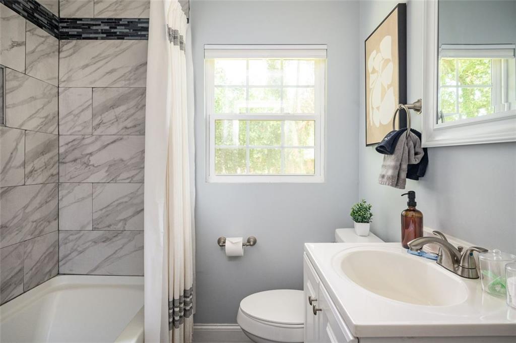 1778 Flintwood Drive Southeast Atlanta, GA 30316 - Photo 15 of 30 a bathroom with a sink toilet and shower
