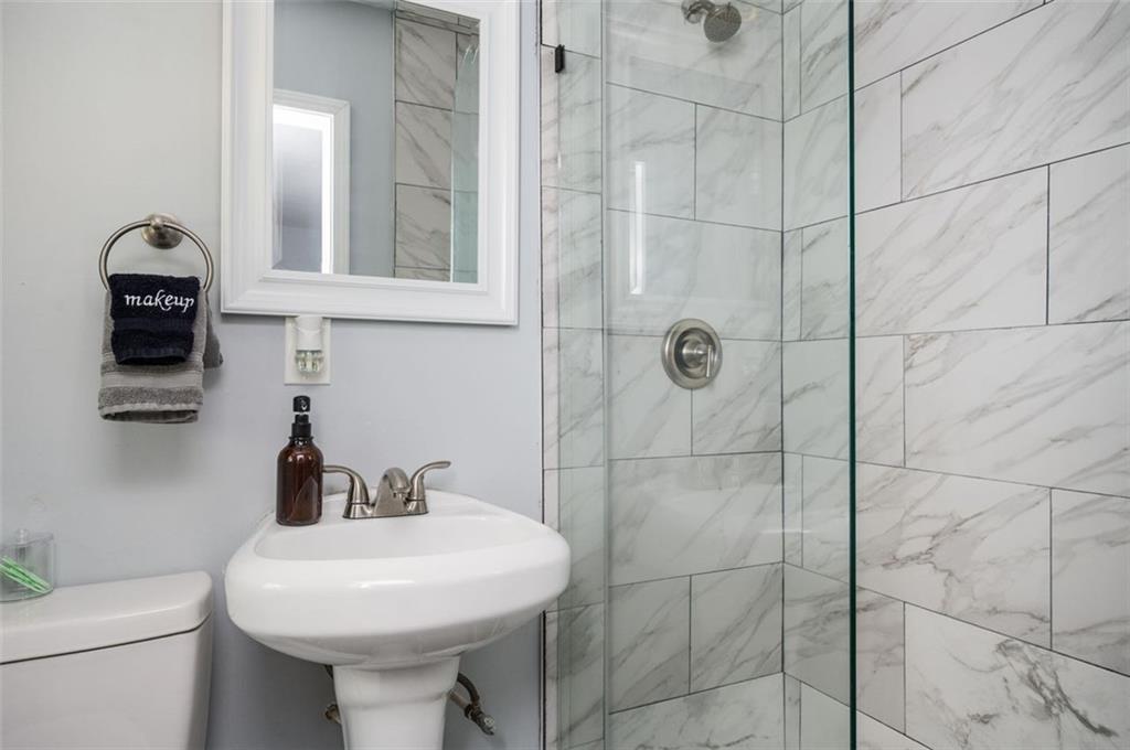 1778 Flintwood Drive Southeast Atlanta, GA 30316 - Photo 18 of 30 a bathroom with a sink toilet and shower