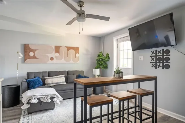 a view of a livingroom with furniture and a flat screen tv
