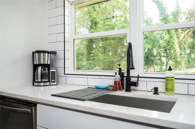 a kitchen with a sink and large window