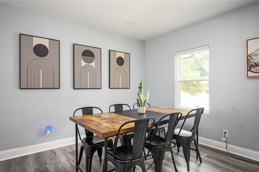 1778 Flintwood Drive Southeast Atlanta, GA 30316 - Photo 8 of 30 a view of a dining room with furniture and wooden floor