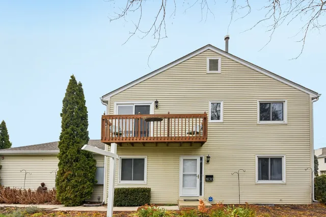 a view of a white house with large windows