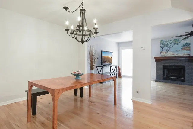 a view of a livingroom with furniture wooden floor a chandelier