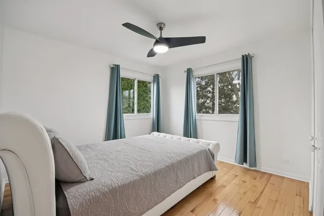 a bedroom with a large bed and a large window