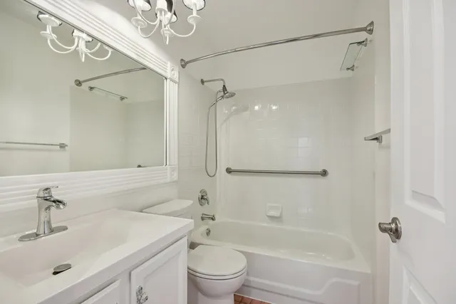a bathroom with a sink mirror toilet and shower