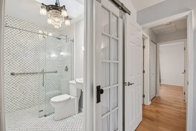 a bathroom with a toilet and a shower