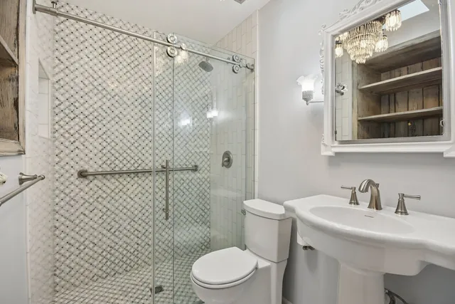 a bathroom with a sink toilet and shower