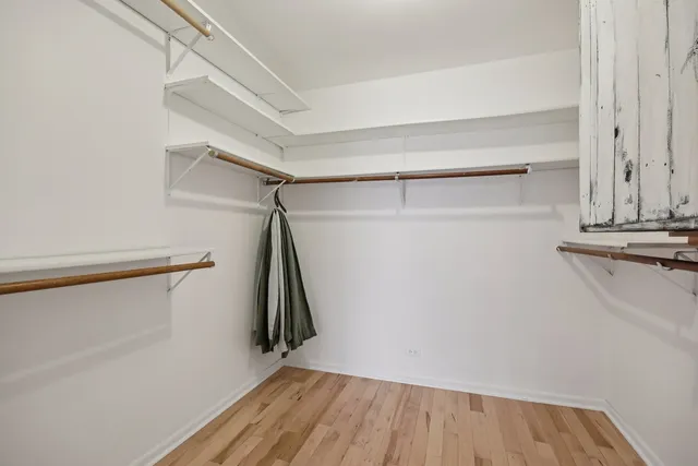 a view of walk in closet with empty racks