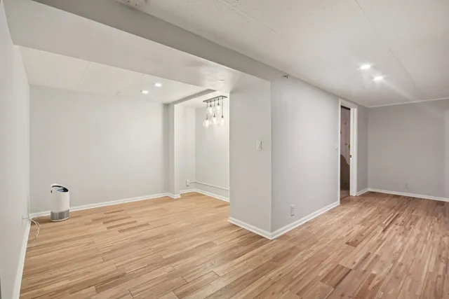 a view of an empty room with wooden floor