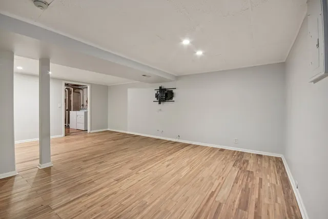 a view of an empty room and wooden floor