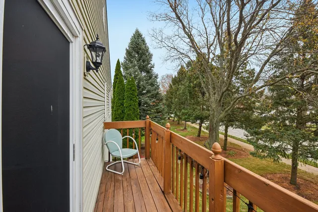 a balcony with wooden floor and outdoor space