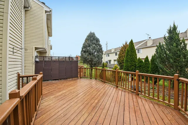 a view of balcony with wooden floor and fence