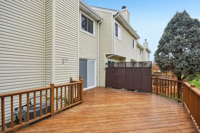 a view of a house with a wooden deck