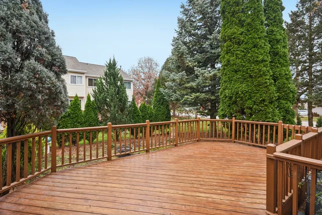 a balcony with wooden floor and fence