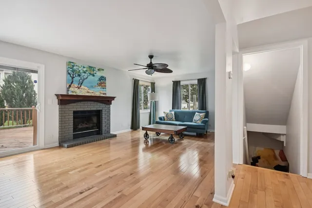 wooden floor in an empty room with a fireplace
