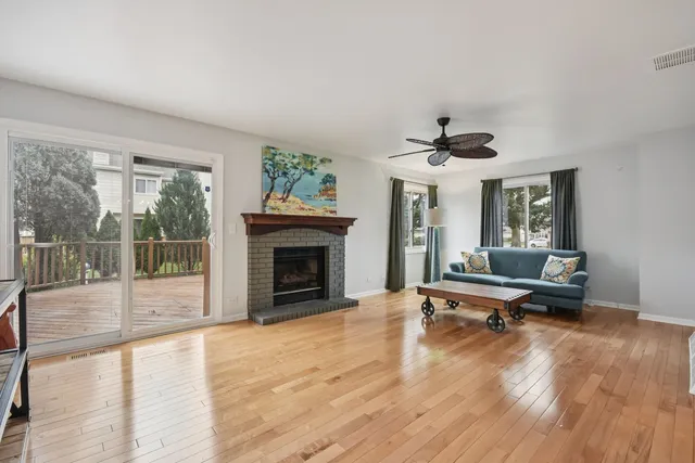 a living room with furniture large window and a fireplace