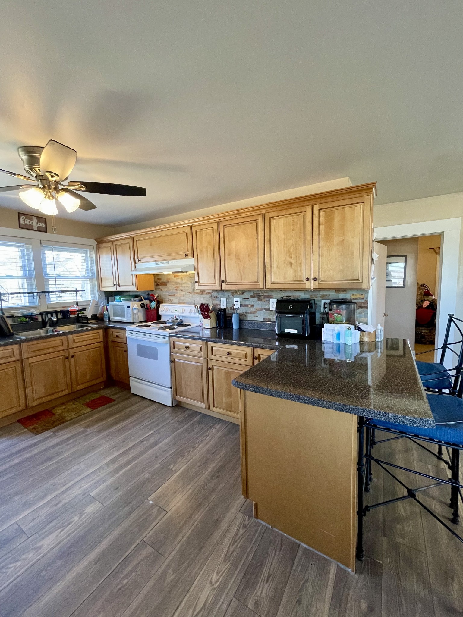 968 West Point Road Lawrenceburg, TN 38464 - Photo 16 of 21 a kitchen with stainless steel appliances granite countertop wooden cabinets a stove a sink a refrigerator and a microwave