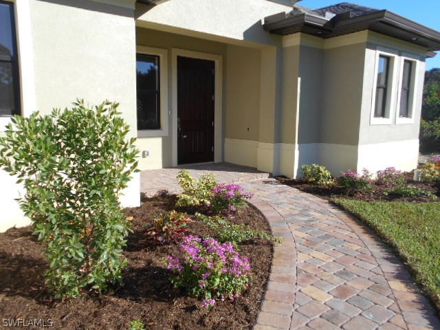 18225 Poplar Road Fort Myers, FL 33967 - Photo 1 of 21 a front view of a house with a yard