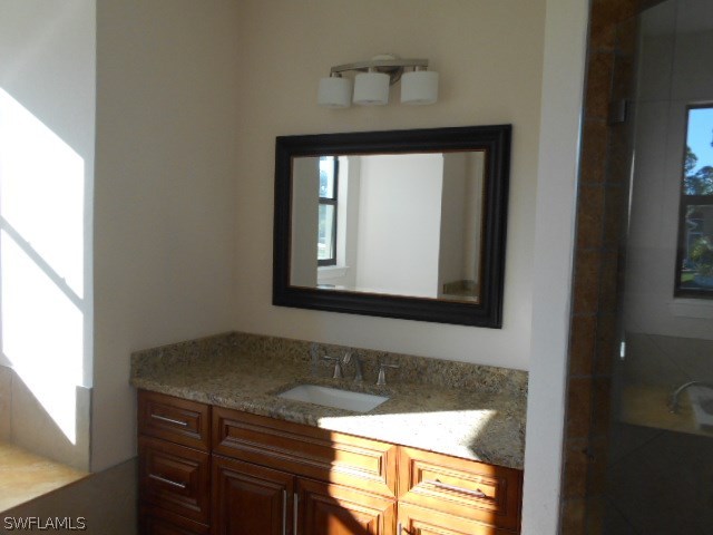 18225 Poplar Road Fort Myers, FL 33967 - Photo 12 of 21 a bathroom with a sink a mirror and a window