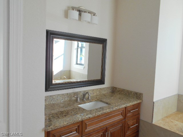 18225 Poplar Road Fort Myers, FL 33967 - Photo 13 of 21 a bathroom with a granite countertop sink and a mirror